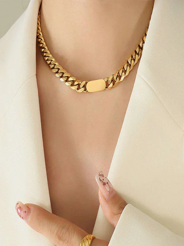 woman wearing dainty gold necklace with outft