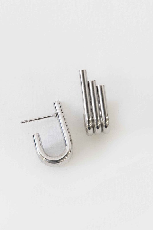 Pair of modern silver earrings on a white background