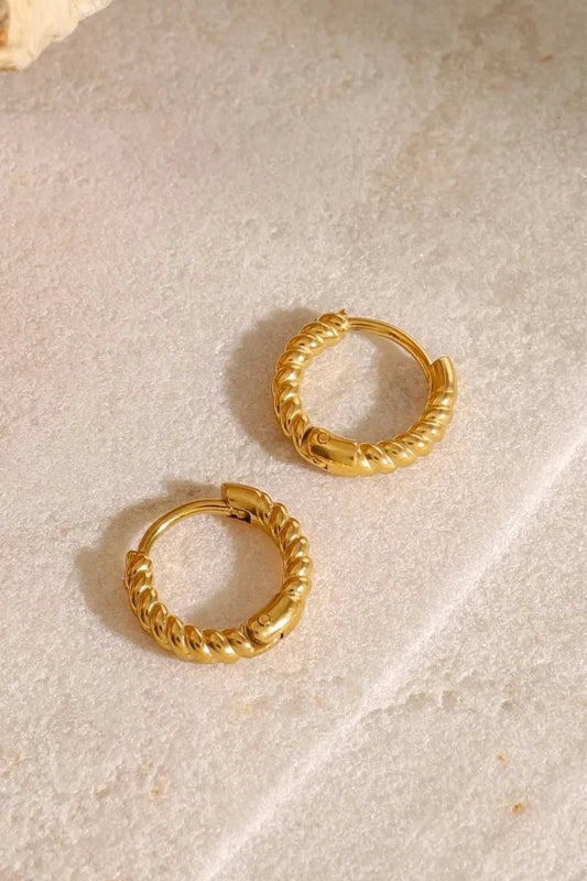 Close-up of twisted 18K gold-plated waterproof huggie earrings